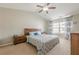 Bedroom featuring a ceiling fan, and large window with patterned curtains at 2705 Maple Park Pl # 29, Cumming, GA 30041