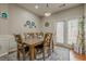 Cozy dining room featuring an elegant light fixture and doors leading to the outside at 2705 Maple Park Pl # 29, Cumming, GA 30041