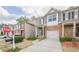 Street view of townhomes with brick accents, attached garages, and well-maintained landscaping at 2705 Maple Park Pl # 29, Cumming, GA 30041