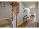 Hallway with wooden floors, stairway, and views of the dining area at 2705 Maple Park Pl # 29, Cumming, GA 30041