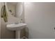 Cozy powder room with pedestal sink and neutral color scheme at 2705 Maple Park Pl # 29, Cumming, GA 30041