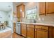 The kitchen includes wood cabinets, stainless steel appliances, and a window overlooking the backyard at 2705 Maple Park Pl # 29, Cumming, GA 30041