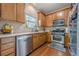 Well-lit kitchen with stainless steel appliances, lots of cabinets, and hardwood floors at 2705 Maple Park Pl # 29, Cumming, GA 30041