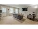 Open-concept living room with neutral carpet, multiple seating areas, and a large TV at 2705 Maple Park Pl # 29, Cumming, GA 30041