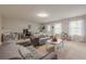 Spacious living room area with neutral paint, large sofas, and natural light from the windows at 2705 Maple Park Pl # 29, Cumming, GA 30041