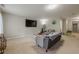 Expansive carpeted living room with furniture, a television, and a well-lit hallway at 2705 Maple Park Pl # 29, Cumming, GA 30041