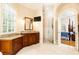 Bright bathroom featuring a large vanity with granite countertop, walk-in shower, and view into the main bedroom at 3022 Loridan Se Way, Atlanta, GA 30339