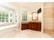 A spa-like bathroom features a soaking tub, dual vanities, and glass-enclosed shower at 3022 Loridan Se Way, Atlanta, GA 30339