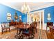 Formal dining room with bright blue walls, crown molding and stylish furnishings at 3022 Loridan Se Way, Atlanta, GA 30339