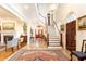 Grand foyer showcases a soaring staircase, gleaming marble floors, and exquisite detailing at 3022 Loridan Se Way, Atlanta, GA 30339