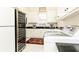 Well-equipped laundry room with white cabinetry, modern appliances, and wine refrigerator at 3022 Loridan Se Way, Atlanta, GA 30339