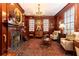 Elegant living room with wood paneling, fireplace, chandelier, and oriental rug at 3022 Loridan Se Way, Atlanta, GA 30339