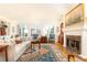 Bright living area featuring a marble fireplace, neutral sofa, hardwood floors, and many windows at 3022 Loridan Se Way, Atlanta, GA 30339
