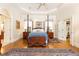 Bright primary bedroom featuring a four-poster bed, hardwood floors, and walk-in closet at 3022 Loridan Se Way, Atlanta, GA 30339