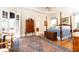 Spacious primary bedroom with four poster bed, tray ceiling, and french doors to the outdoor space at 3022 Loridan Se Way, Atlanta, GA 30339