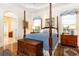 Elegant primary bedroom with beautiful hardwood floors, chest, and tray ceiling at 3022 Loridan Se Way, Atlanta, GA 30339
