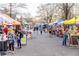 Bustling outdoor market scene featuring various vendors, colorful tents, and community members at 3022 Loridan Se Way, Atlanta, GA 30339