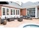 Attractive brick patio featuring outdoor seating, a fire pit, a dining table, and a spa surrounded by brick at 3022 Loridan Se Way, Atlanta, GA 30339