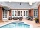 Brick patio featuring a pool and spa, outdoor seating, and a brick facade with many white doors and windows at 3022 Loridan Se Way, Atlanta, GA 30339