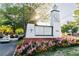 Community sign showcasing Vinings Jubilee, nearby shops, vibrant landscaping, and a clock tower at 3022 Loridan Se Way, Atlanta, GA 30339