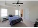 This bedroom features a ceiling fan, windows with blinds, and ensuite bath at 3725 Rifflewood Way, Douglasville, GA 30135