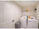 This laundry room has shelving for storage, as well as a washer and dryer at 3725 Rifflewood Way, Douglasville, GA 30135