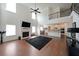 Open-concept living room with high ceilings, fireplace, and seamless access to the kitchen area at 3725 Rifflewood Way, Douglasville, GA 30135