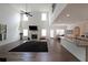 Bright living room with a fireplace, high ceilings, and an open floor plan to the kitchen at 3725 Rifflewood Way, Douglasville, GA 30135