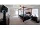This main bedroom is spacious with a four poster bed, ceiling fan, and large windows at 3725 Rifflewood Way, Douglasville, GA 30135