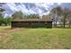 The rear view of the home reveals a well-maintained lawn and home with a kayak at 38 E Boxwood Se Dr, Cartersville, GA 30121