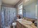 Bathroom featuring a window and a tub/shower combo with seashell patterned shower curtain at 38 E Boxwood Se Dr, Cartersville, GA 30121