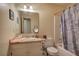 Bathroom with a window over the sink and a shower/tub with patterned shower curtain at 38 E Boxwood Se Dr, Cartersville, GA 30121