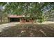 Charming exterior of green home with a covered porch and driveway offering curb appeal at 38 E Boxwood Se Dr, Cartersville, GA 30121