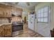 Efficient kitchen with wood cabinets, stainless steel oven, and wood-look laminate flooring at 38 E Boxwood Se Dr, Cartersville, GA 30121