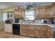Functional kitchen with wood cabinets, black appliances, and wood-look laminate flooring at 38 E Boxwood Se Dr, Cartersville, GA 30121