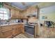 Bright kitchen with wood cabinets, stainless steel oven, and wood-look laminate flooring at 38 E Boxwood Se Dr, Cartersville, GA 30121