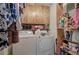 Functional laundry room with washer, dryer, shelving, and overhead cabinets at 38 E Boxwood Se Dr, Cartersville, GA 30121