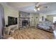 Bright living room featuring a stone fireplace and wood-look laminate floors at 38 E Boxwood Se Dr, Cartersville, GA 30121