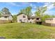 Expansive backyard featuring lush green grass, mature trees, and a wooden privacy fence at 5429 Golfcrest Cir, Stone Mountain, GA 30088