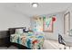 Bright bedroom with dinosaur themed bedding, decor, and natural lighting at 5429 Golfcrest Cir, Stone Mountain, GA 30088