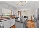 Bright kitchen with stainless appliances and an island overlooking dining area at 5429 Golfcrest Cir, Stone Mountain, GA 30088
