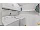 Bright laundry room with washer, dryer and storage shelving at 5429 Golfcrest Cir, Stone Mountain, GA 30088