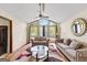 Bright living room featuring a vaulted ceiling, large windows, hardwood floors, and cozy furniture at 5429 Golfcrest Cir, Stone Mountain, GA 30088