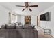 Cozy living room features a stone fireplace, ceiling fan, and natural light at 5429 Golfcrest Cir, Stone Mountain, GA 30088