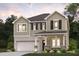 Two-story home featuring stone accents, an attached garage, and landscaped front yard at 7200 Brushwood Bend - Lot 117, Lithonia, GA 30058