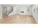 Spacious living room featuring wood floors, modern fireplace, and plenty of natural light at 7200 Brushwood Bend - Lot 117, Lithonia, GA 30058