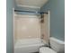 Cozy bathroom featuring a shower over bath and a white toilet at 1717 Ramblewood Way, Snellville, GA 30078