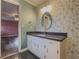Charming bathroom featuring granite counters, bird-themed wallpaper, and unique oval mirror at 1717 Ramblewood Way, Snellville, GA 30078