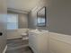 Bright bathroom with wainscoting, gray walls, and a minimalist white sink vanity at 1717 Ramblewood Way, Snellville, GA 30078