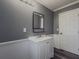 Modern bathroom featuring gray walls, a white sink vanity, and minimalist decor at 1717 Ramblewood Way, Snellville, GA 30078